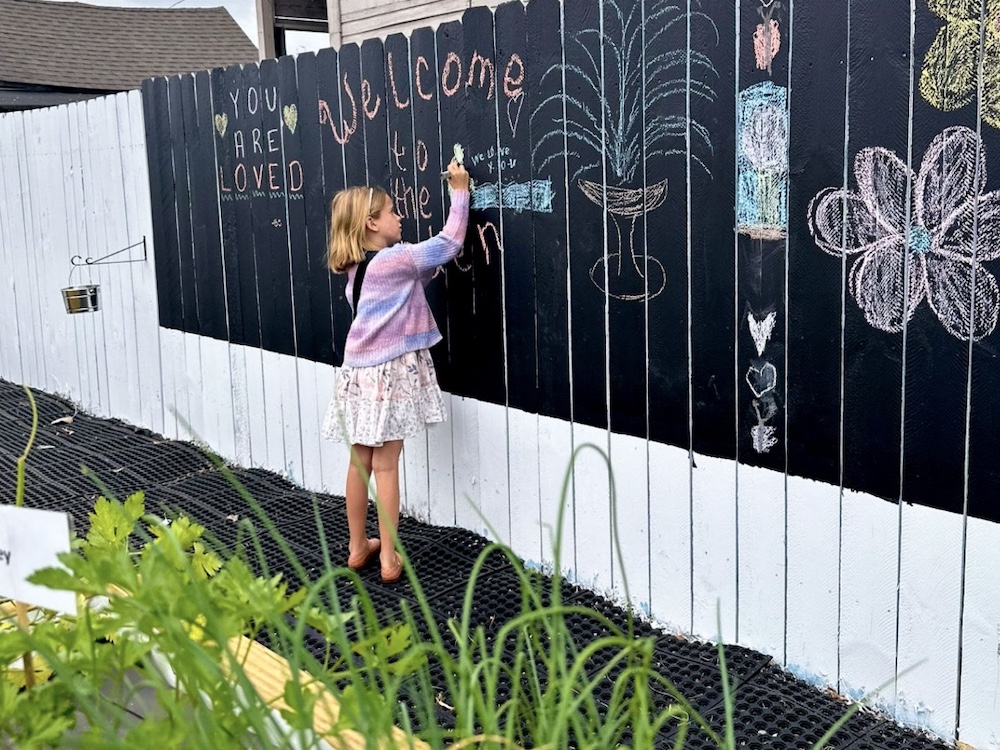 Screenshot Child decorating Threshold's sensory garden