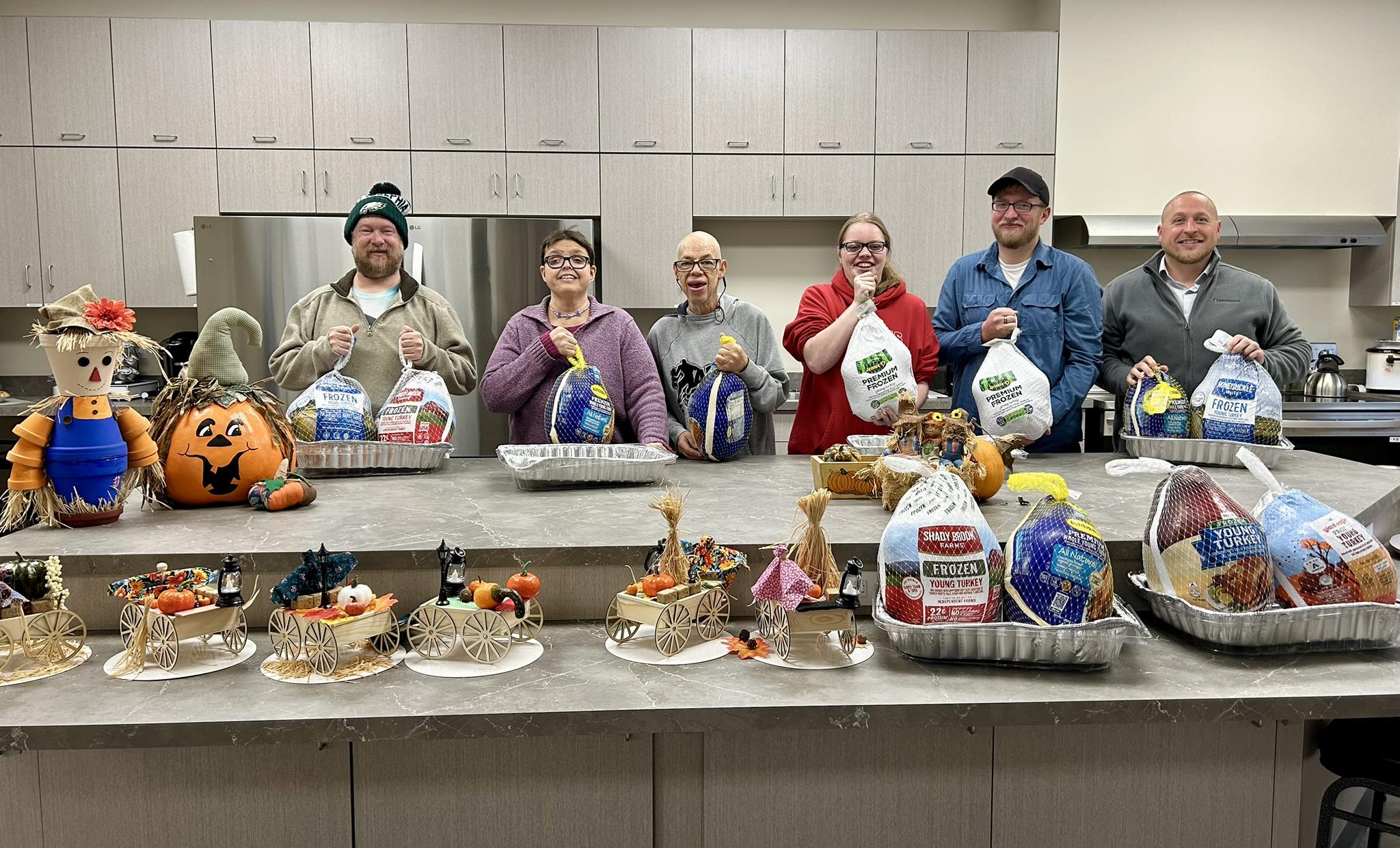 People holding donated turkeys
